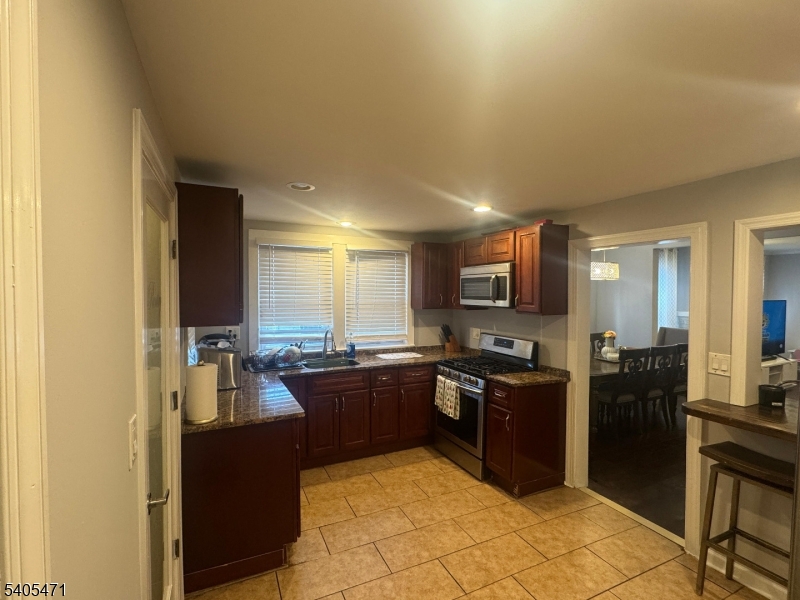 835 Dixie Lane Plainfield, NJ 07062 - Photo 7 of 37 a kitchen with stainless steel appliances granite countertop a sink stove and refrigerator