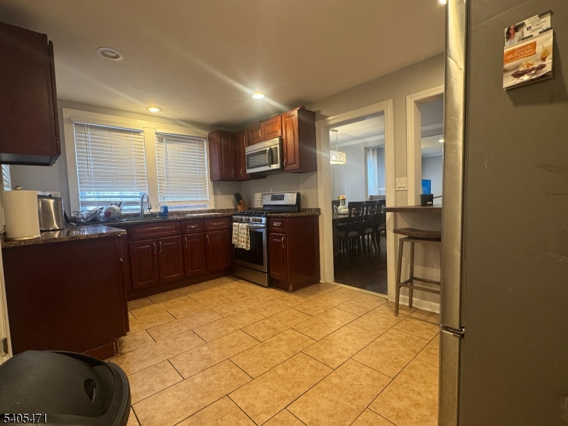 835 Dixie Lane Plainfield, NJ 07062 - Photo 9 of 37 a kitchen with stainless steel appliances granite countertop a refrigerator and a stove top oven