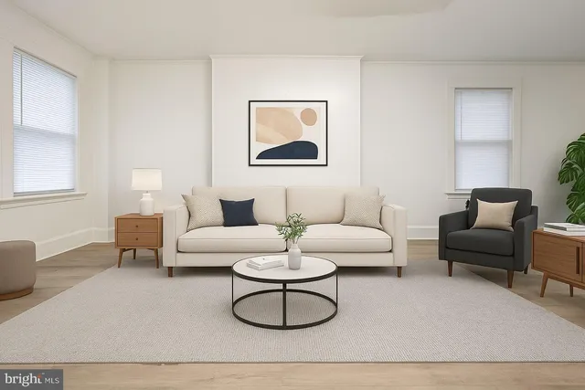 a living room with furniture a rug and a lamp