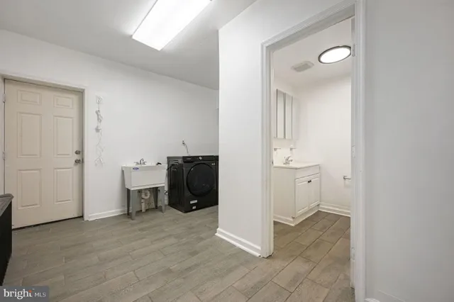 an entryway view with a sink and a refrigerator