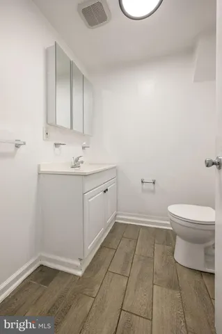 a bathroom with a toilet a sink and mirror