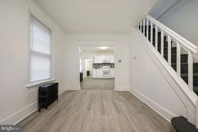 a view of a hallway view with wooden floor and staircase