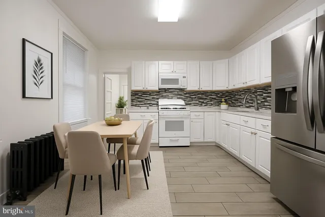 a kitchen with stainless steel appliances granite countertop a stove a sink a table and chairs