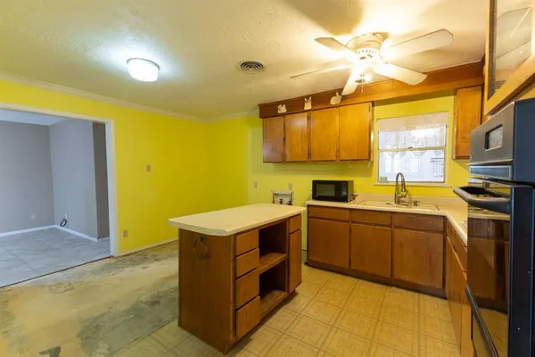 a kitchen with a sink appliances and cabinets