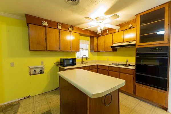 a kitchen with stainless steel appliances a stove a sink and a refrigerator