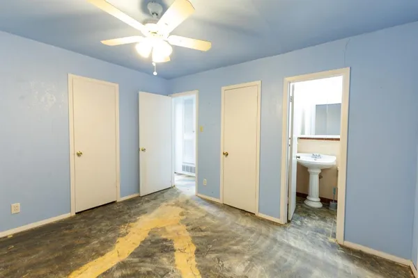 a view of a room with a chandelier fan and entryway