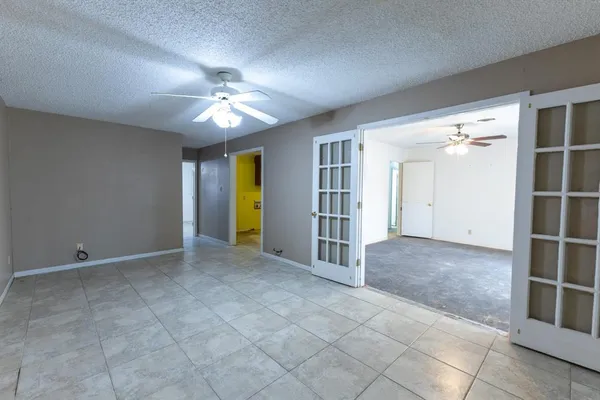 an empty room with closet and windows