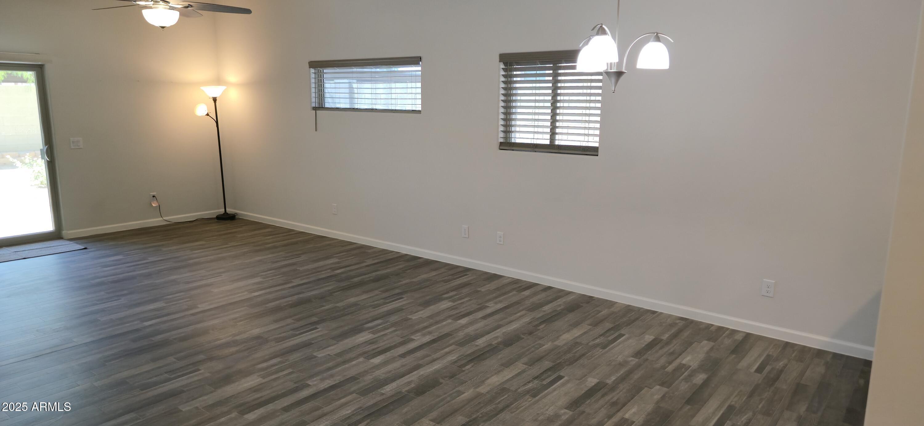 701 Dylan Court Wickenburg, AZ 85390 - Photo 11 of 29 an empty room with wooden floor and windows