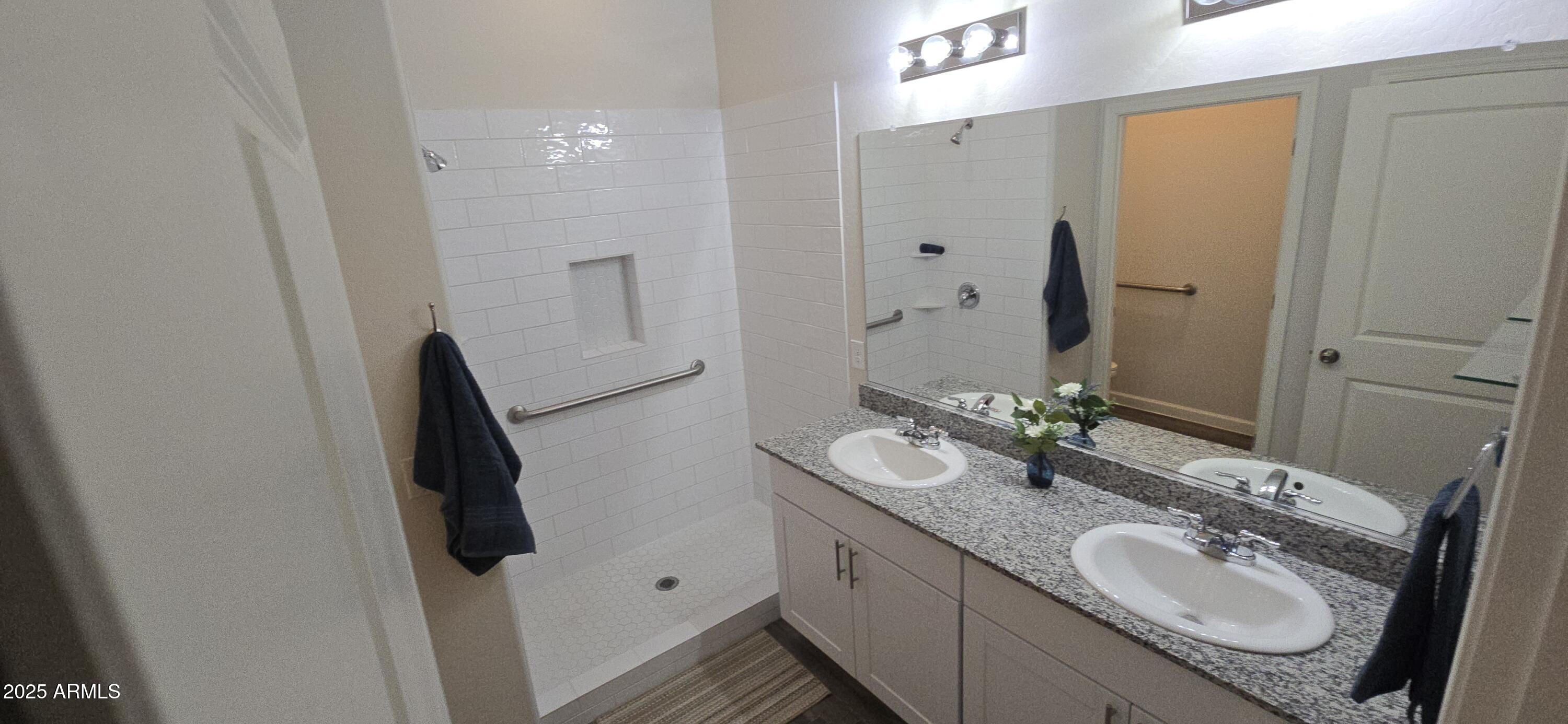 701 Dylan Court Wickenburg, AZ 85390 - Photo 16 of 29 a bathroom with a granite countertop sink and a mirror