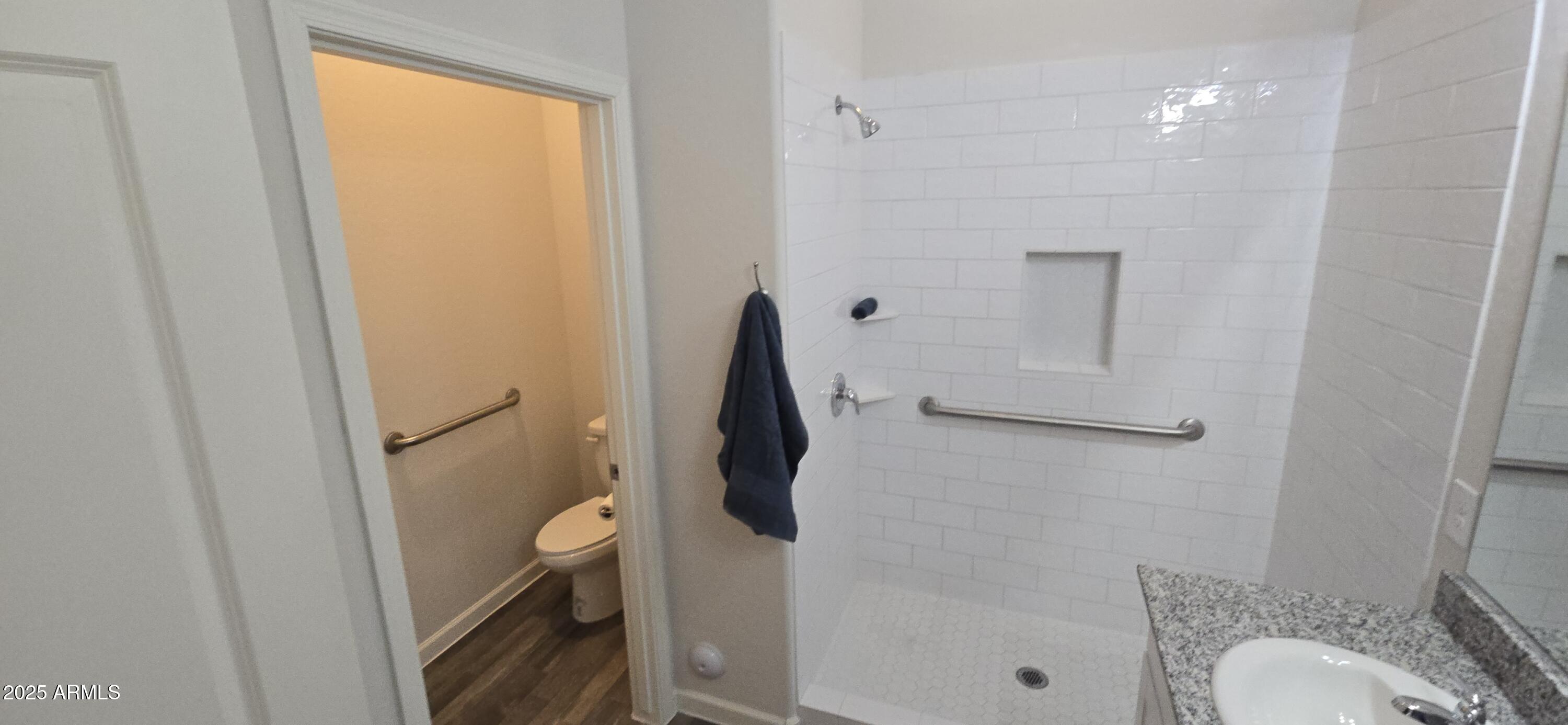 701 Dylan Court Wickenburg, AZ 85390 - Photo 17 of 29 a bathroom with a granite countertop toilet and a shower