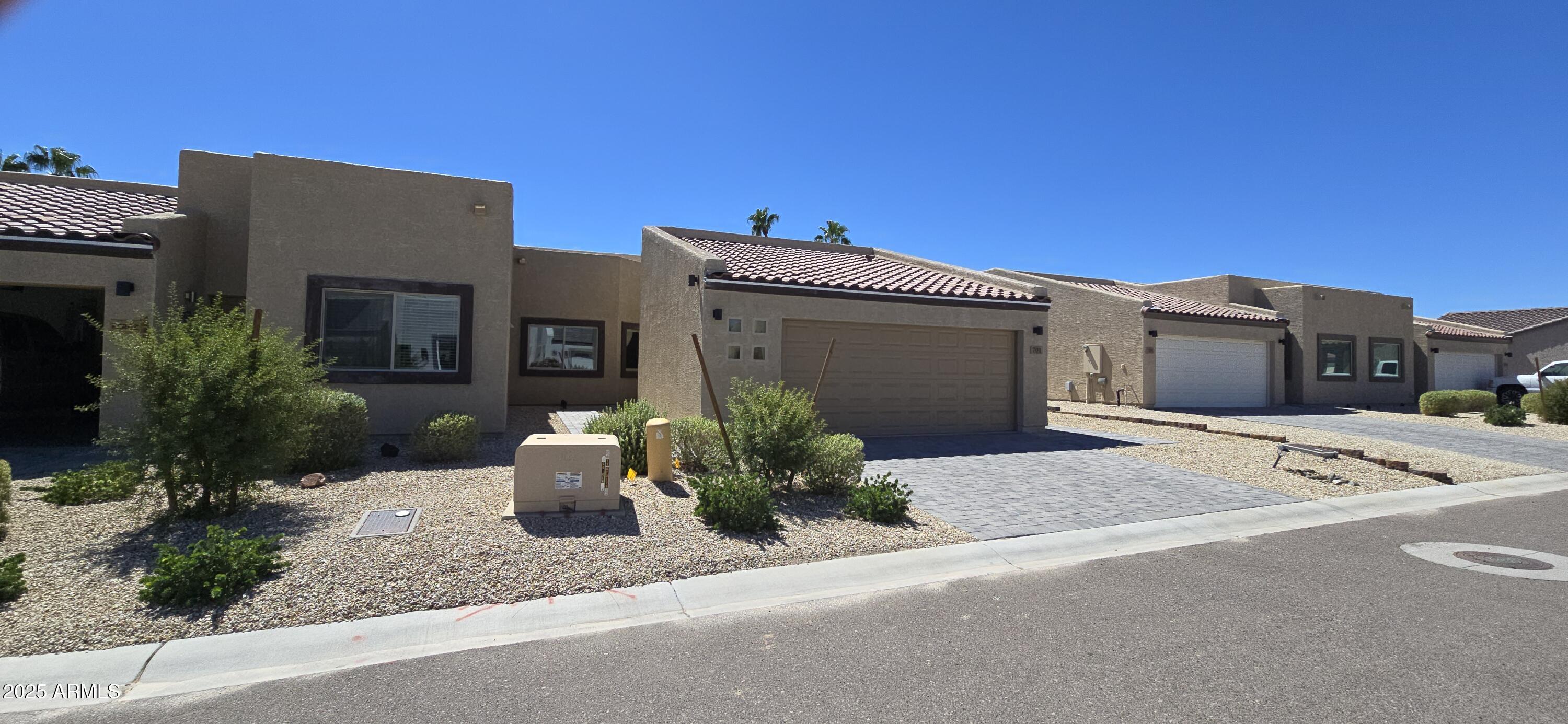 701 Dylan Court Wickenburg, AZ 85390 - Photo 2 of 29 a front view of a house with a yard and garage