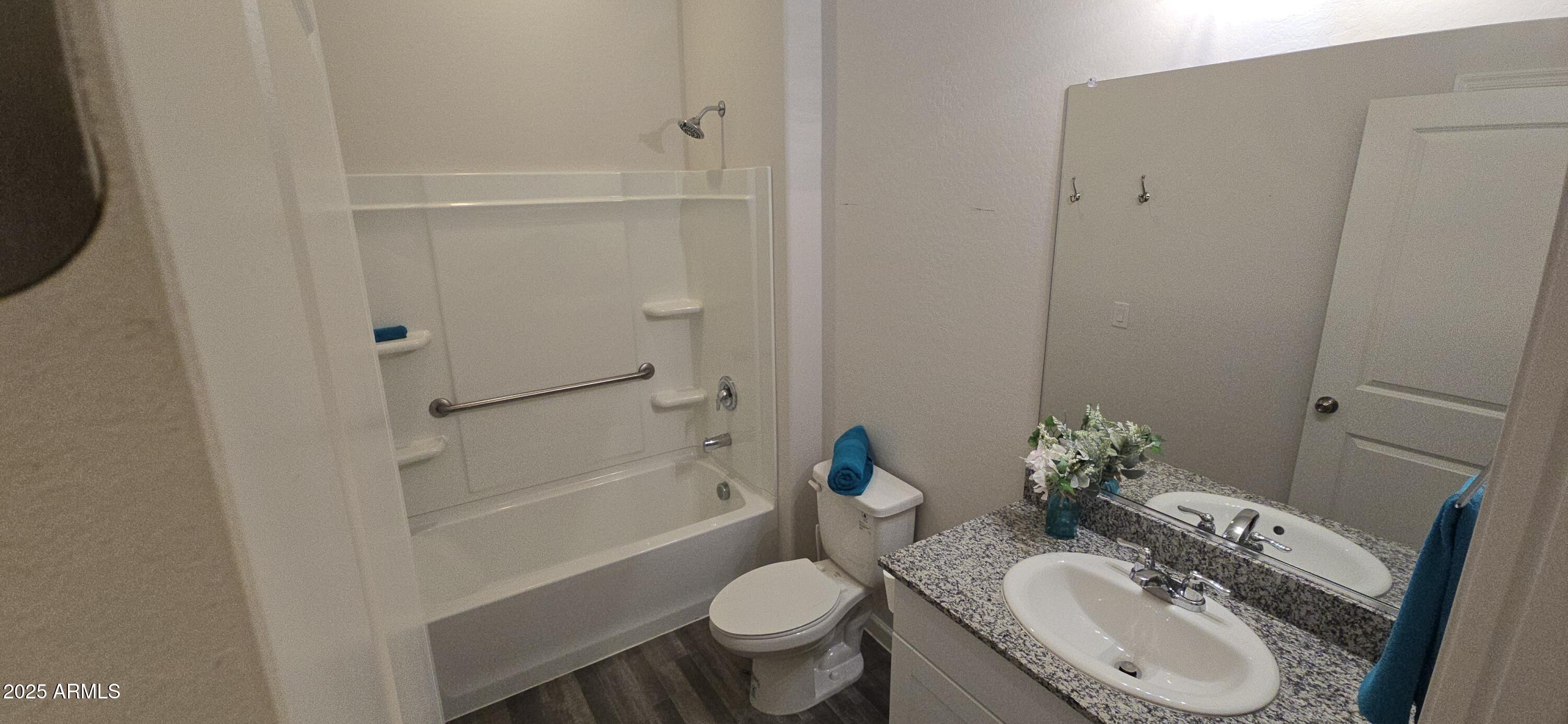 701 Dylan Court Wickenburg, AZ 85390 - Photo 24 of 29 a bathroom with a granite countertop sink toilet and shower
