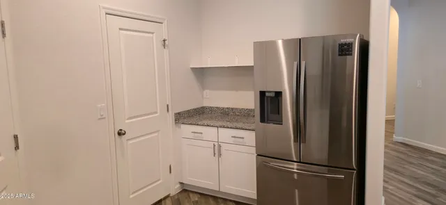 a kitchen with metallic refrigerator freezer and a dishwasher