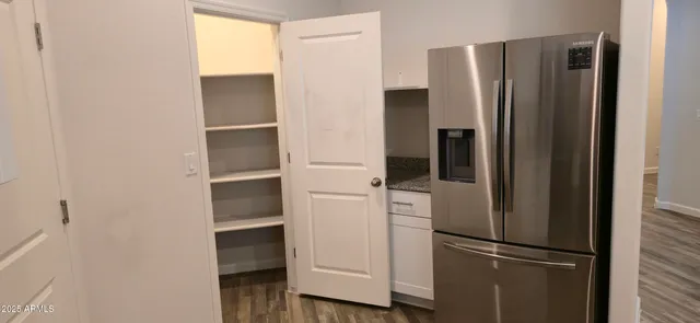 a room with a refrigerator and cabinets