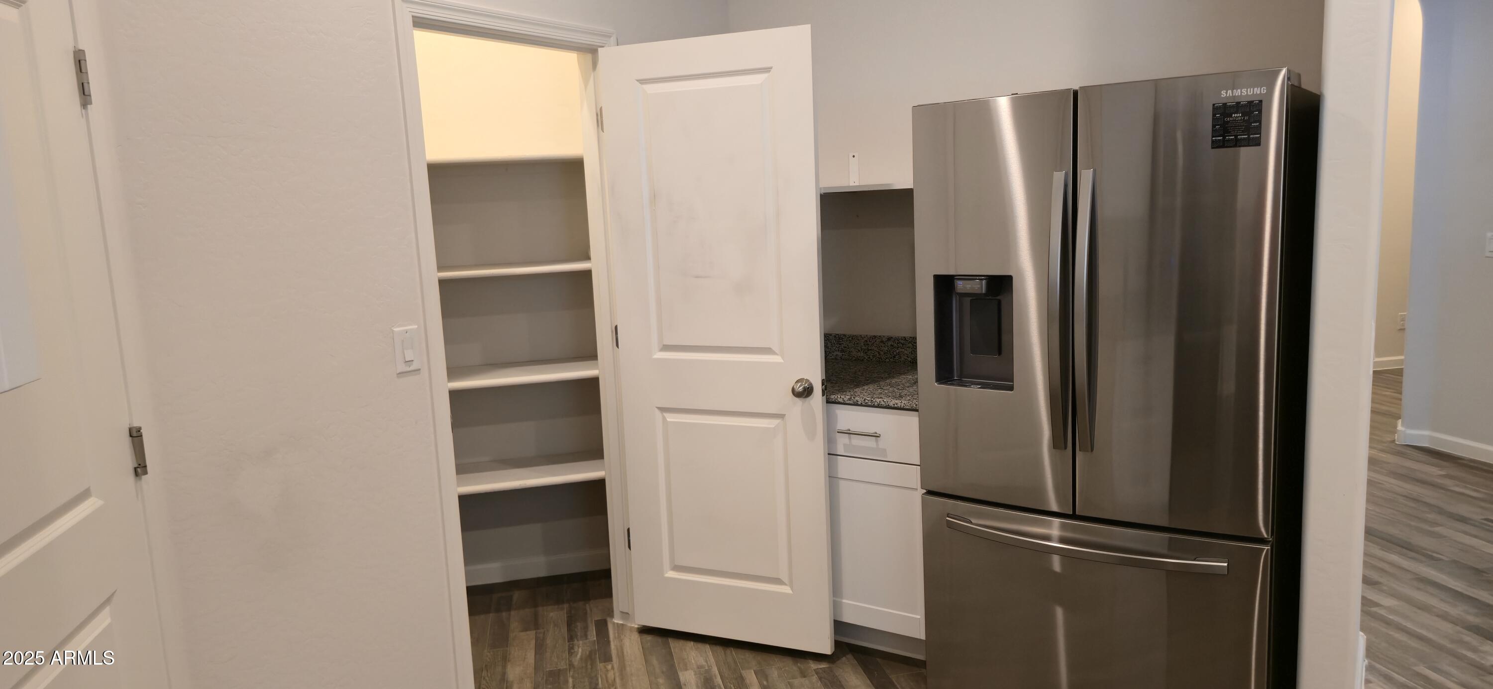 701 Dylan Court Wickenburg, AZ 85390 - Photo 7 of 29 a room with a refrigerator and cabinets