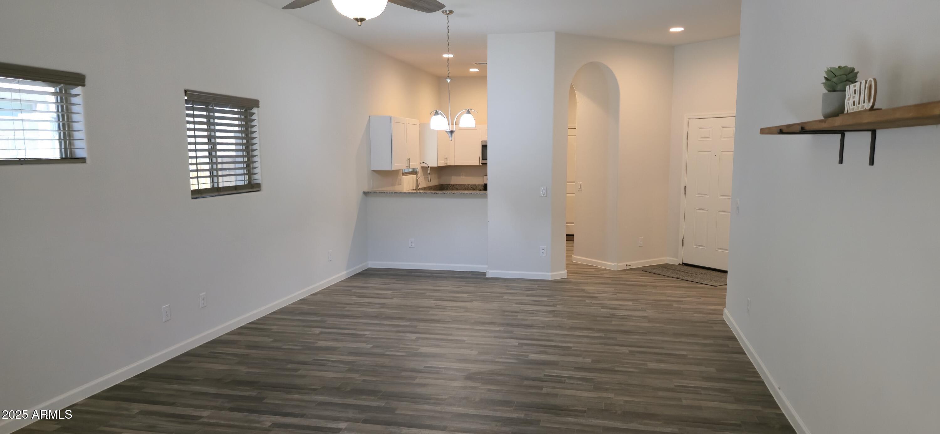701 Dylan Court Wickenburg, AZ 85390 - Photo 8 of 29 wooden floor in an empty room with a window