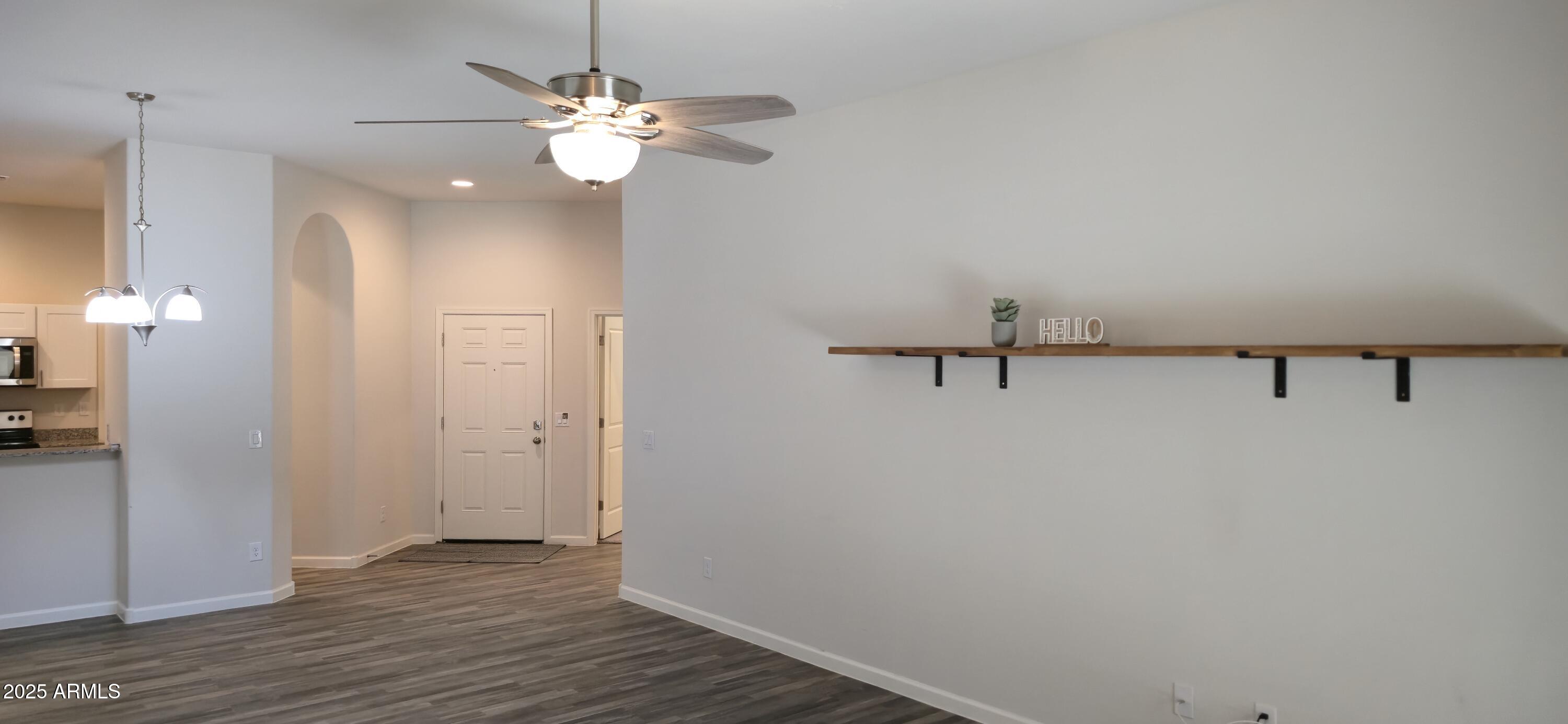 701 Dylan Court Wickenburg, AZ 85390 - Photo 10 of 29 a view of a room with a hanging light and hardwood floor