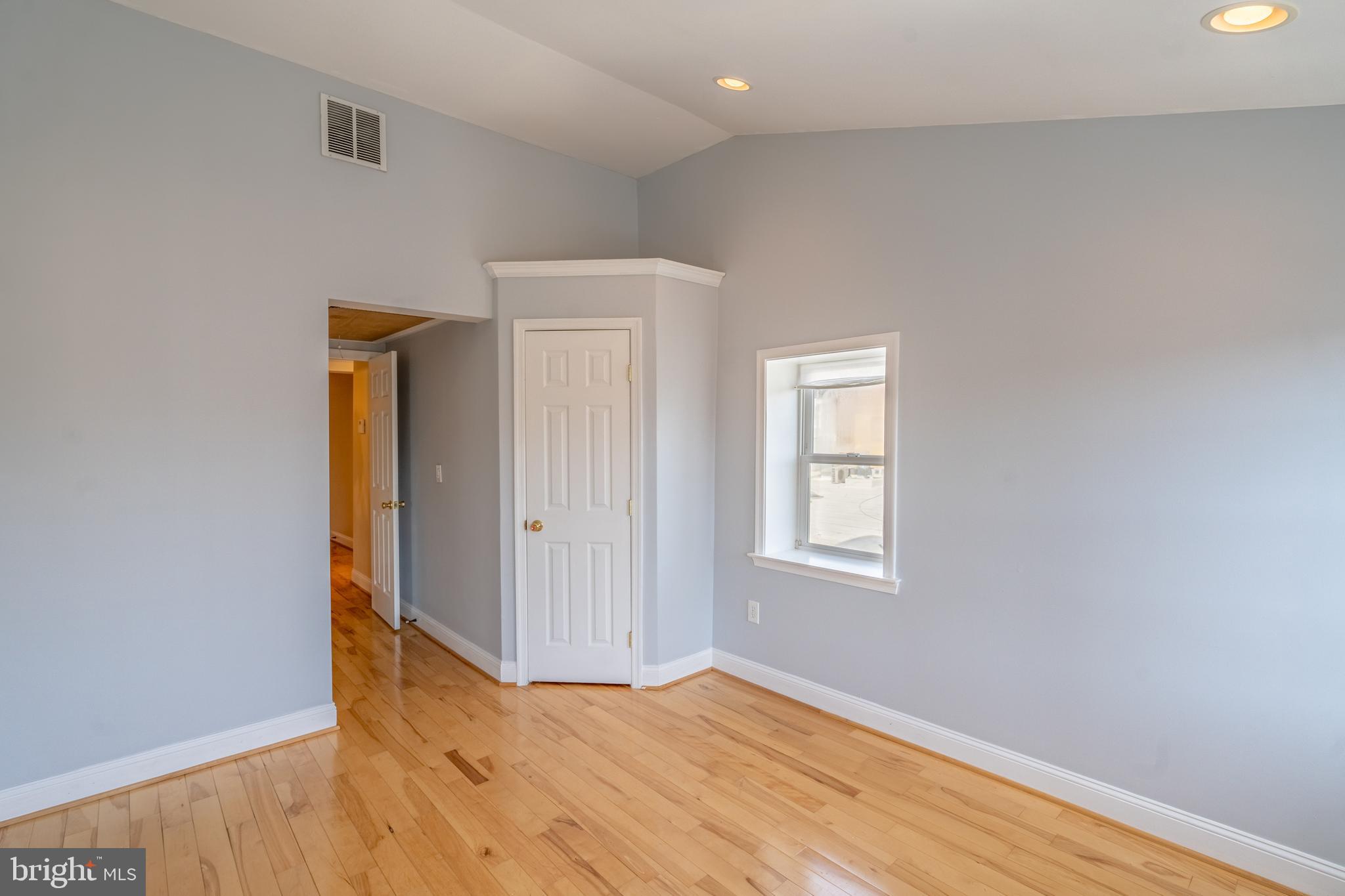 508 Scott Street Baltimore, MD 21230 - Photo 21 of 63 a view of an empty room with wooden floor and a window