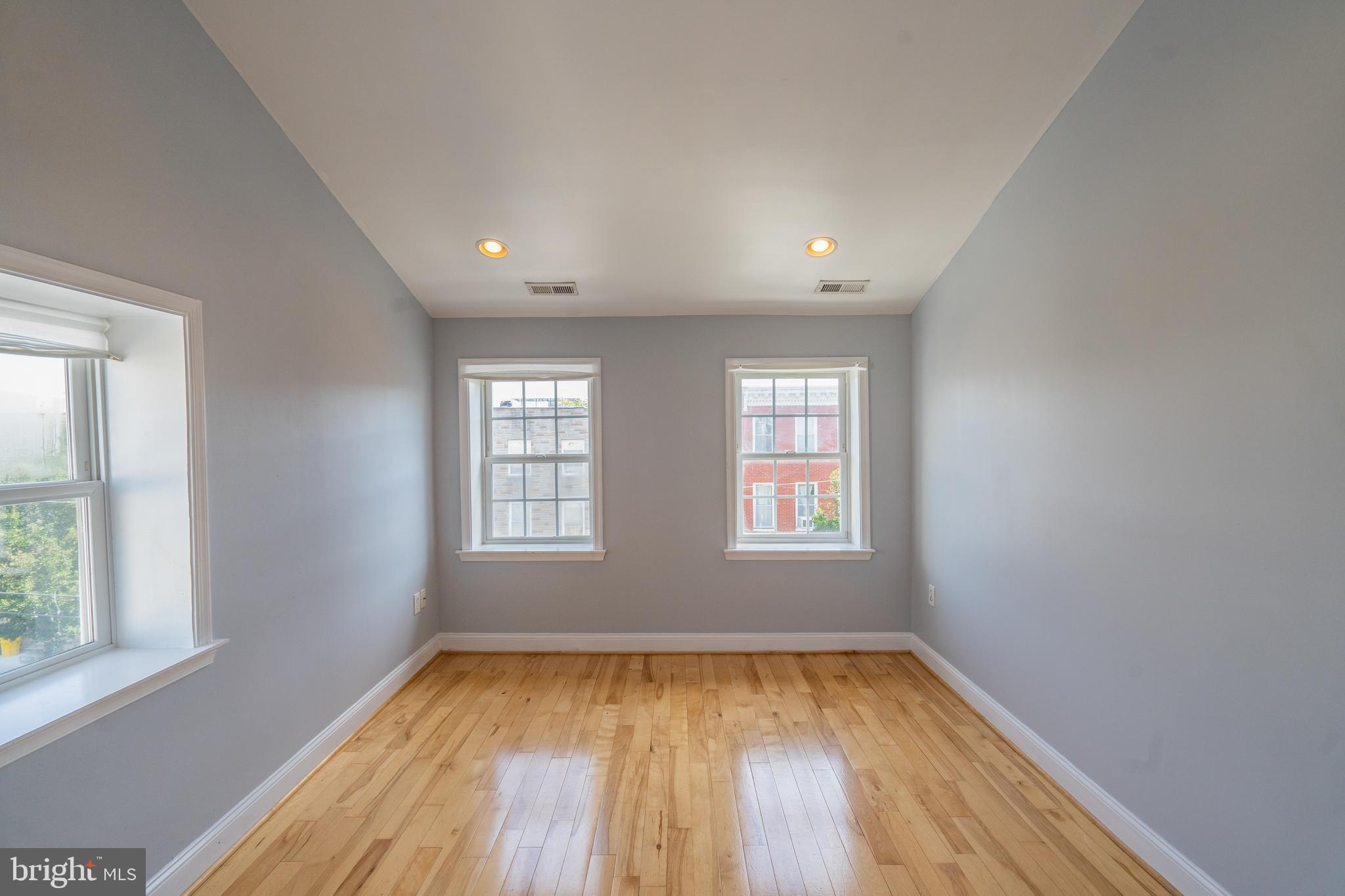 508 Scott Street Baltimore, MD 21230 - Photo 22 of 63 an empty room with wooden floor and windows
