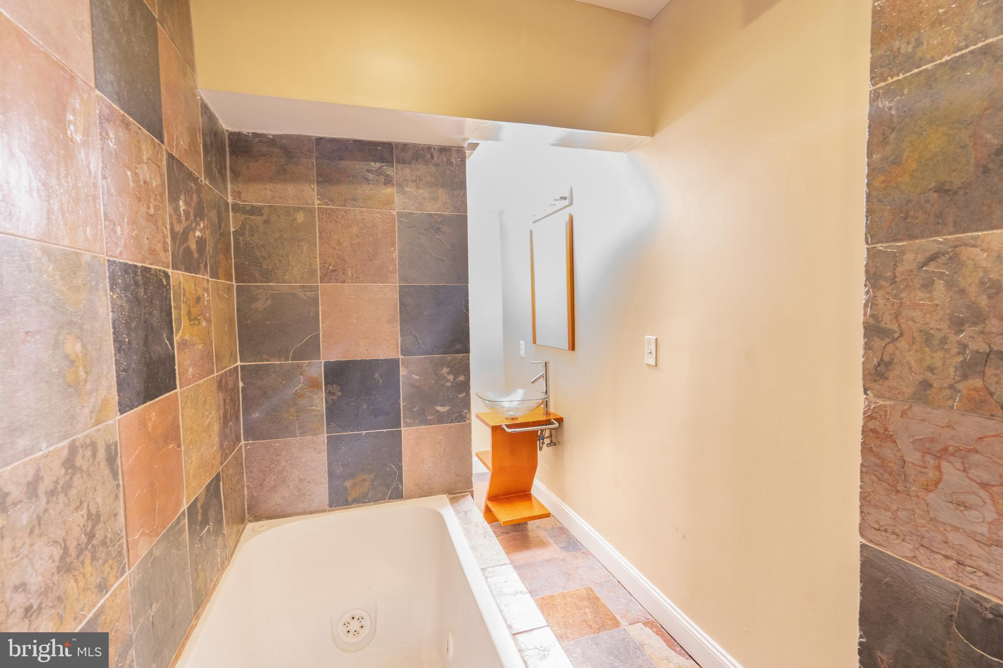 508 Scott Street Baltimore, MD 21230 - Photo 24 of 63 a bathroom with a bathtub and shower