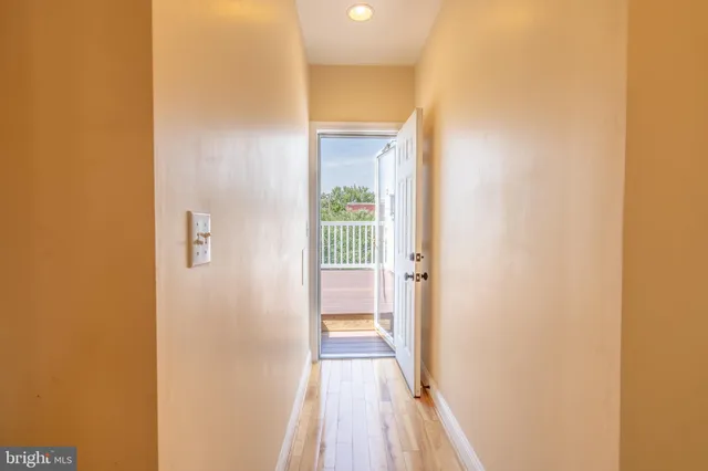 a view of a balcony with wooden floor and fence
