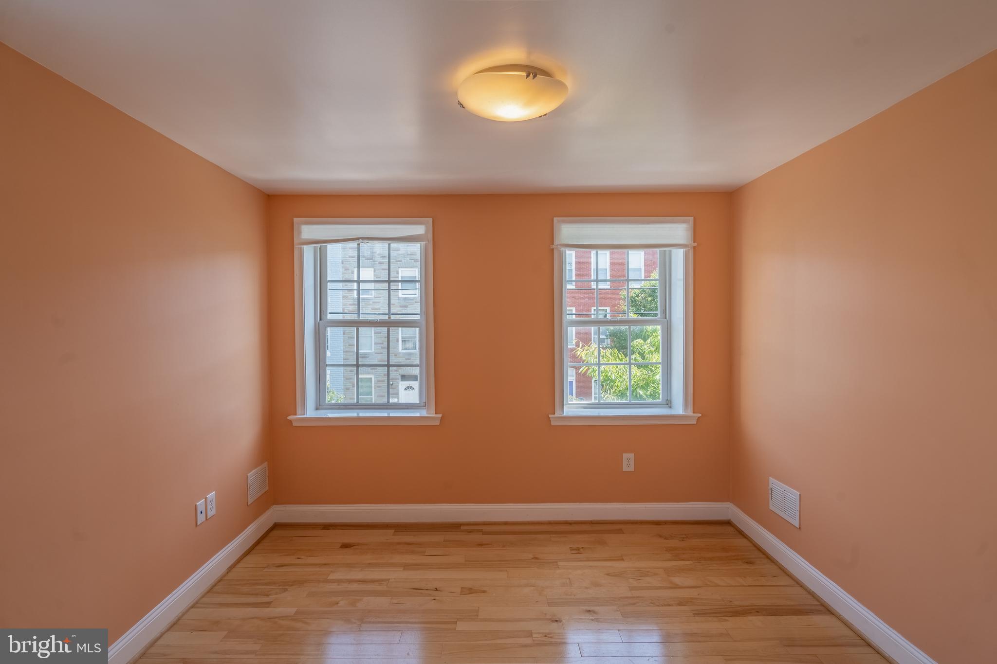 508 Scott Street Baltimore, MD 21230 - Photo 39 of 63 an empty room with wooden floor and windows