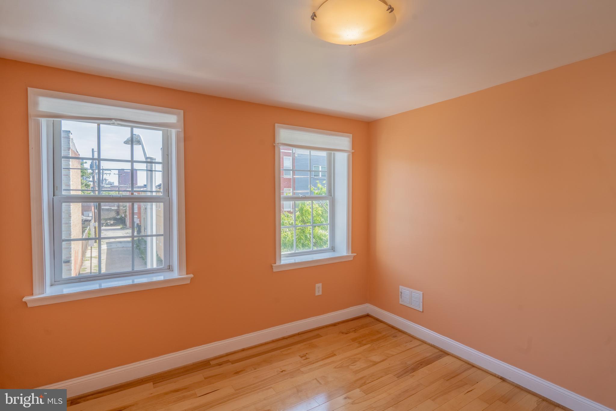 508 Scott Street Baltimore, MD 21230 - Photo 40 of 63 an empty room with wooden floor and windows