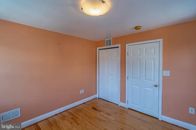 a view of hallway with wooden floor