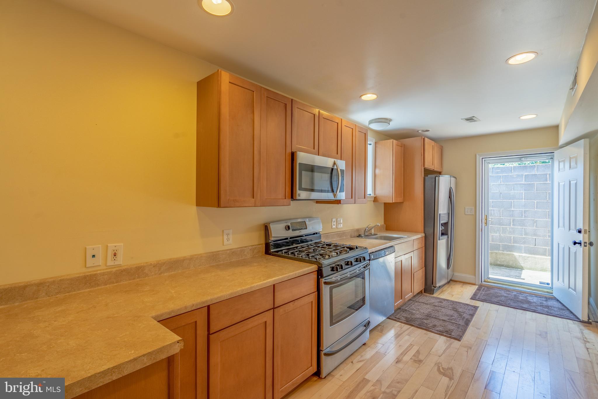 508 Scott Street Baltimore, MD 21230 - Photo 50 of 63 a kitchen with stainless steel appliances granite countertop a stove a sink and a refrigerator