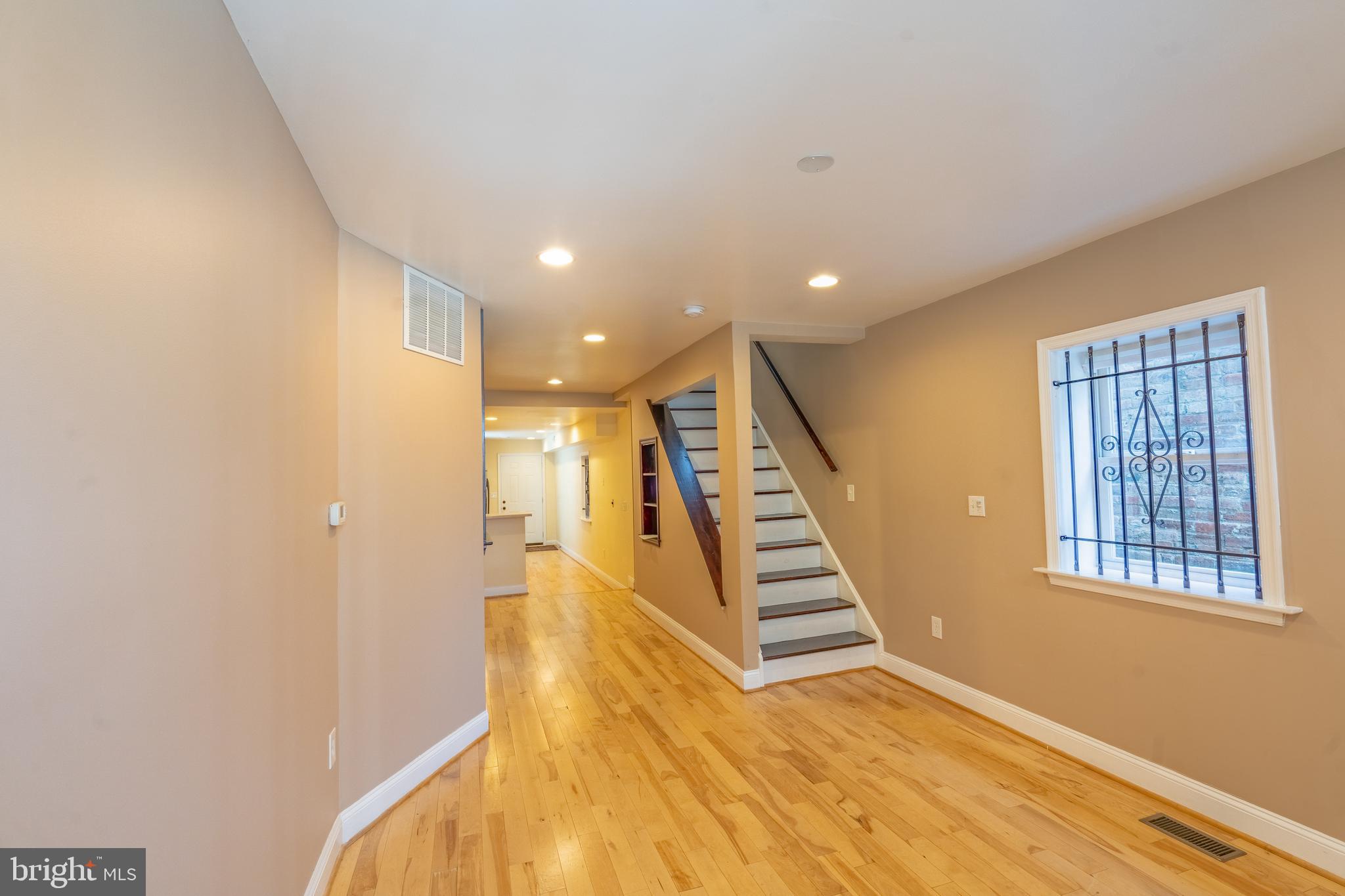 508 Scott Street Baltimore, MD 21230 - Photo 5 of 63 a view of a hallway with wooden floor and staircase