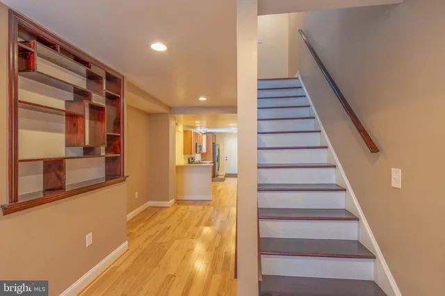 a view of hallway with wooden floor