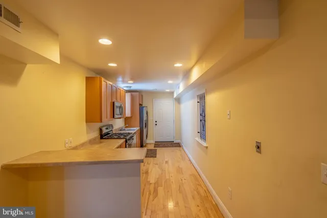 a view of a room with wooden floor and furniture