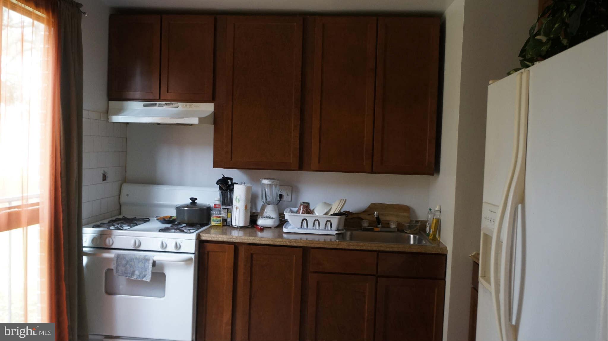 7971 Riggs Road, Unit 2 Hyattsville, MD 20783 - Photo 3 of 13 a kitchen with a sink and cabinets