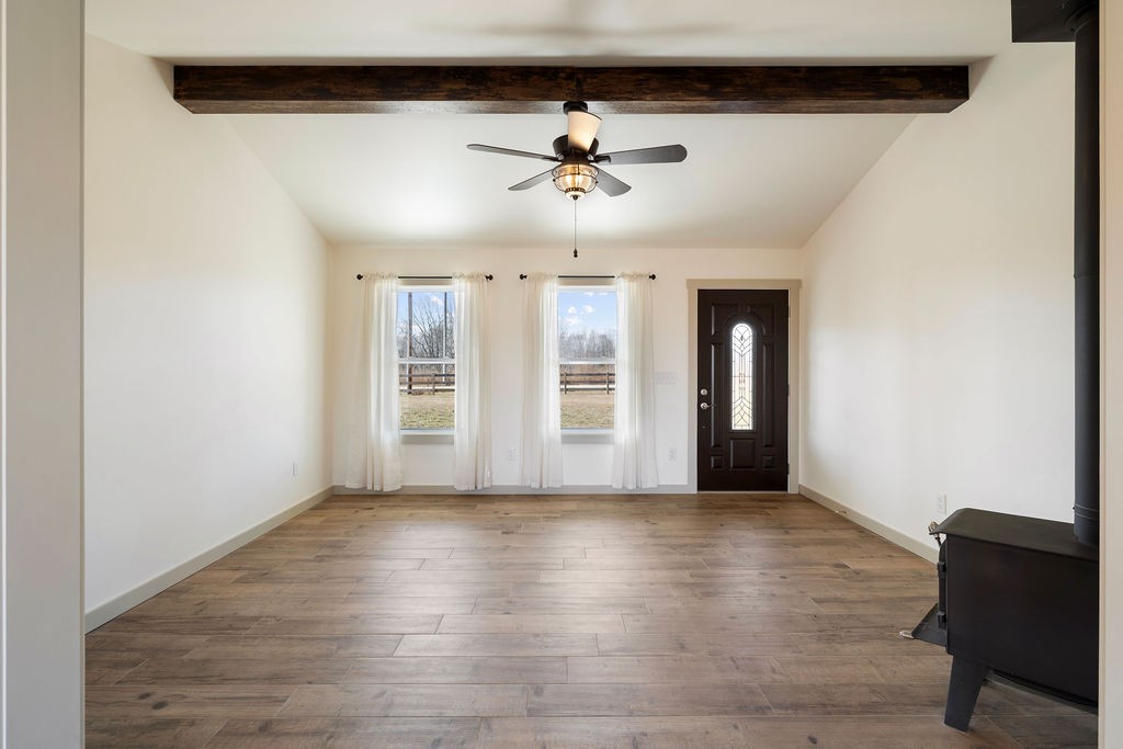 198 Beartown Road Loretto, TN 38469 - Photo 11 of 36 a view of a livingroom with wooden floor and a ceiling fan