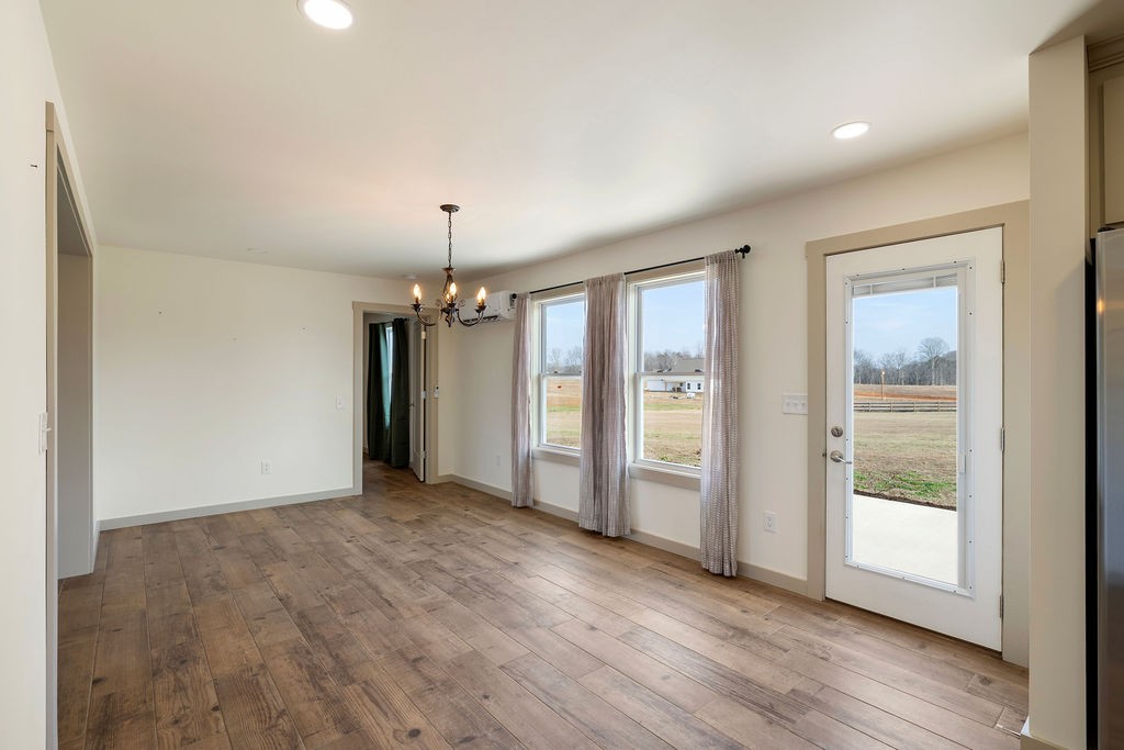 198 Beartown Road Loretto, TN 38469 - Photo 14 of 36 an empty room with wooden floor and windows