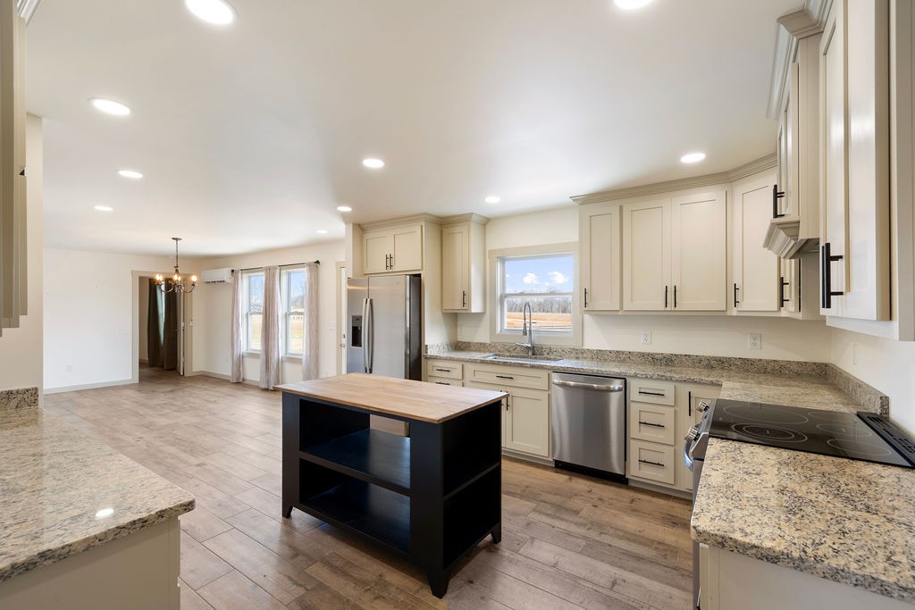 198 Beartown Road Loretto, TN 38469 - Photo 16 of 36 a large kitchen with kitchen island a sink stainless steel appliances and cabinets
