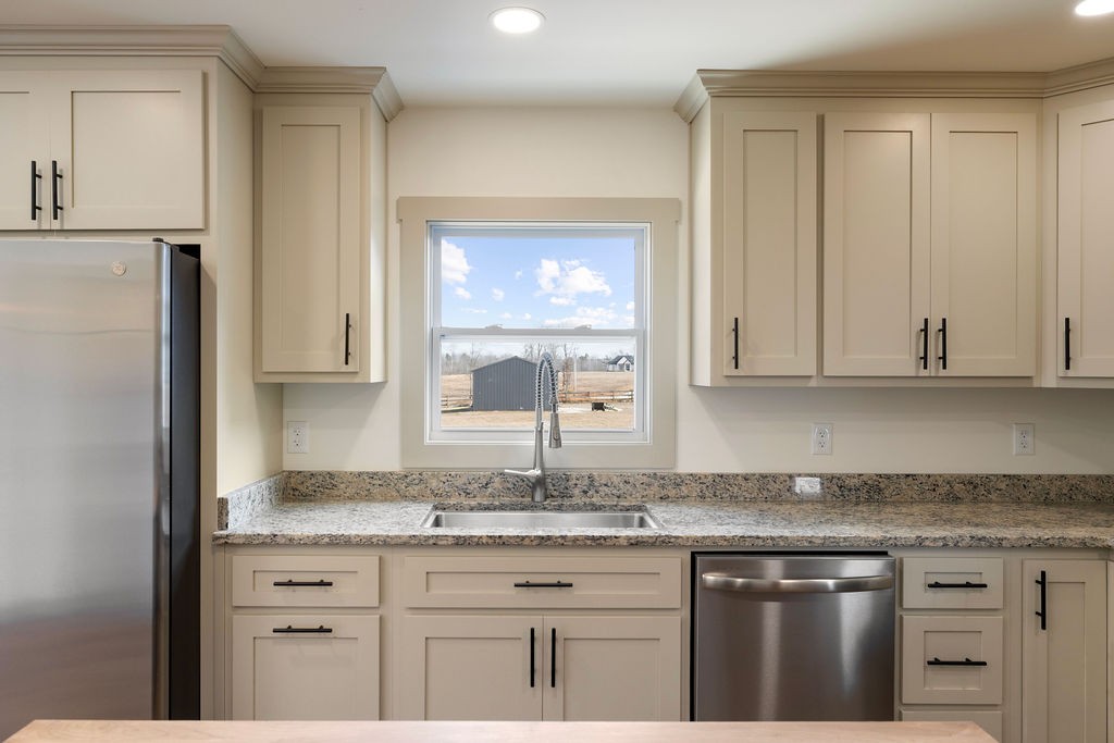 198 Beartown Road Loretto, TN 38469 - Photo 17 of 36 a kitchen with granite countertop cabinets and window