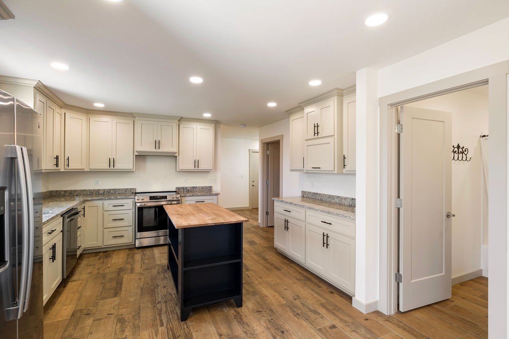 198 Beartown Road Loretto, TN 38469 - Photo 18 of 36 a kitchen with white cabinets and stainless steel appliances