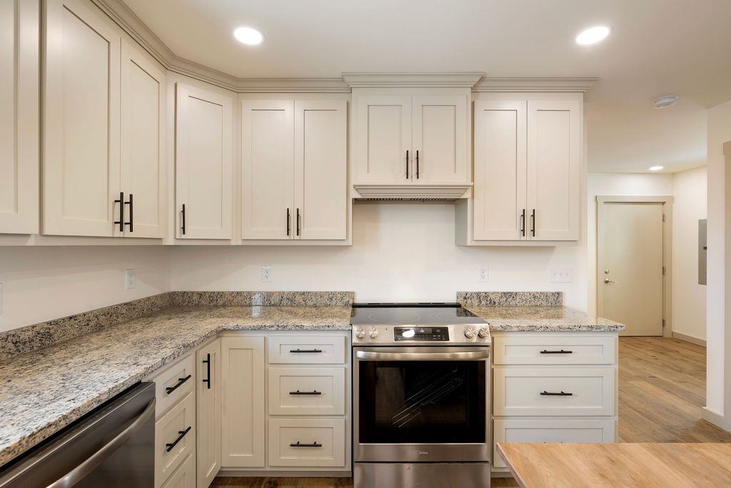 198 Beartown Road Loretto, TN 38469 - Photo 19 of 36 a kitchen with granite countertop white cabinets and white appliances