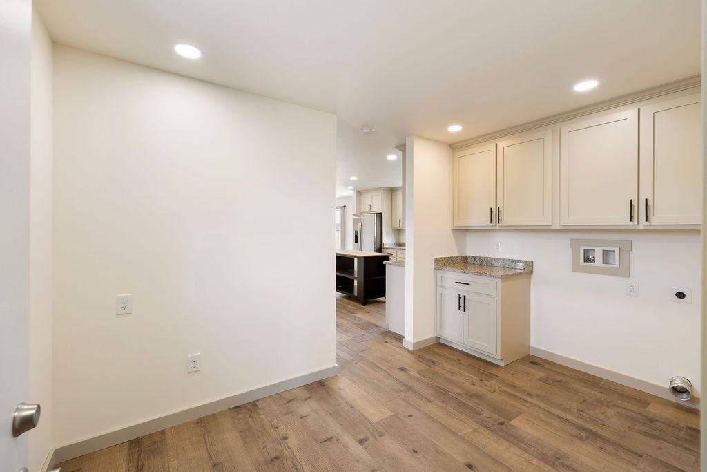 198 Beartown Road Loretto, TN 38469 - Photo 22 of 36 a view of a kitchen with a sink and dishwasher a refrigerator with wooden floor