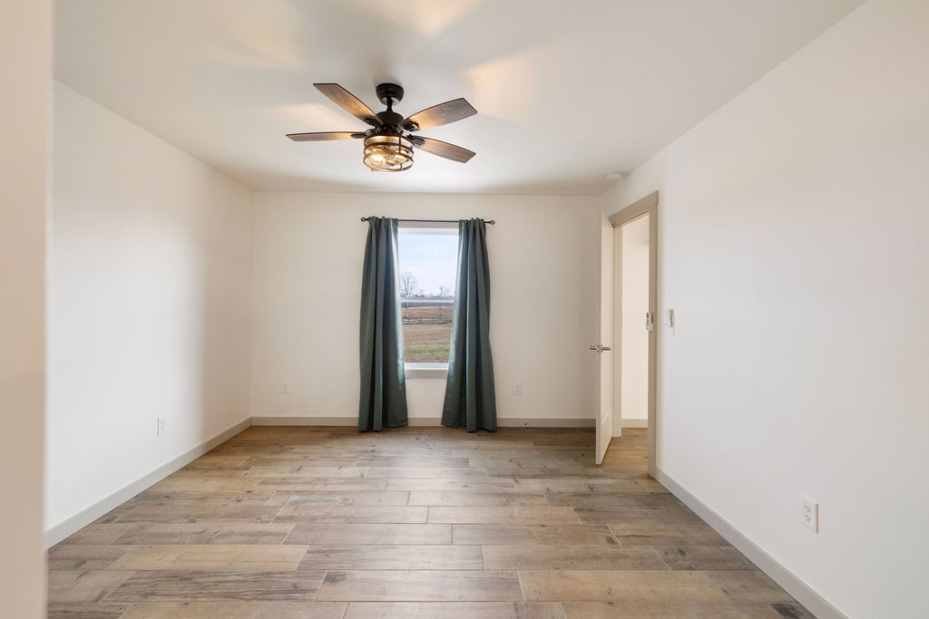 198 Beartown Road Loretto, TN 38469 - Photo 24 of 36 wooden floor in an empty room with a window