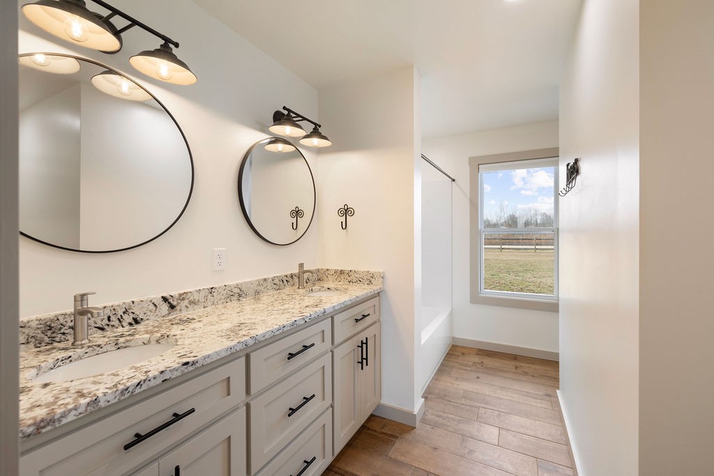 198 Beartown Road Loretto, TN 38469 - Photo 25 of 36 a bathroom with a granite countertop double vanity sink and a mirror