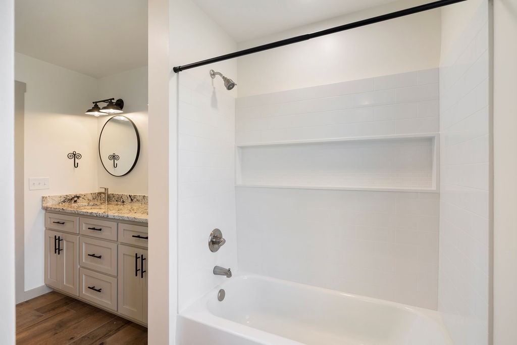 198 Beartown Road Loretto, TN 38469 - Photo 26 of 36 a bathroom with a granite countertop bathtub shower sink and mirror