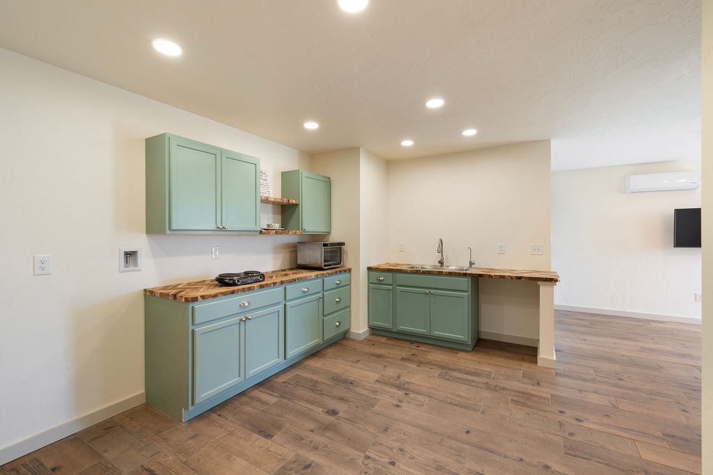 198 Beartown Road Loretto, TN 38469 - Photo 29 of 36 a kitchen with stainless steel appliances granite countertop a sink and a stove top oven