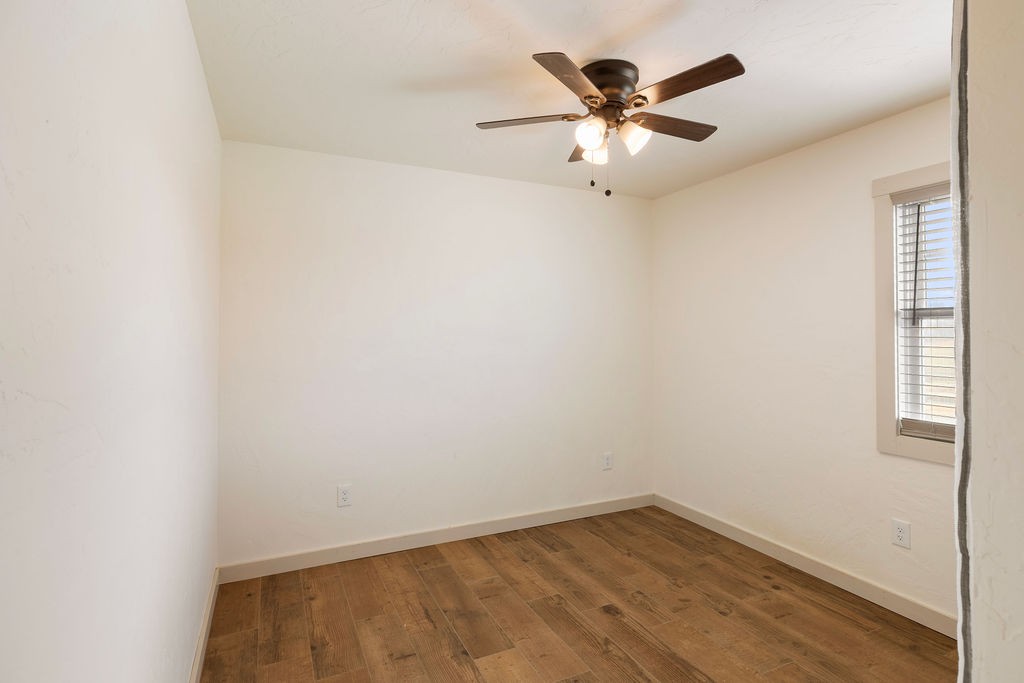 198 Beartown Road Loretto, TN 38469 - Photo 31 of 36 an empty room with wooden floor and ceiling fan