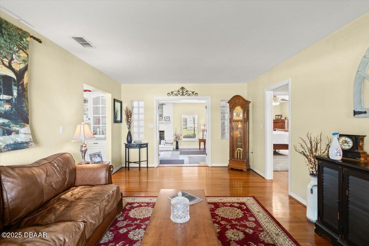 1005 North Kepler Road DeLand, FL 32724 - Photo 16 of 57 a living room with furniture and a wooden floor