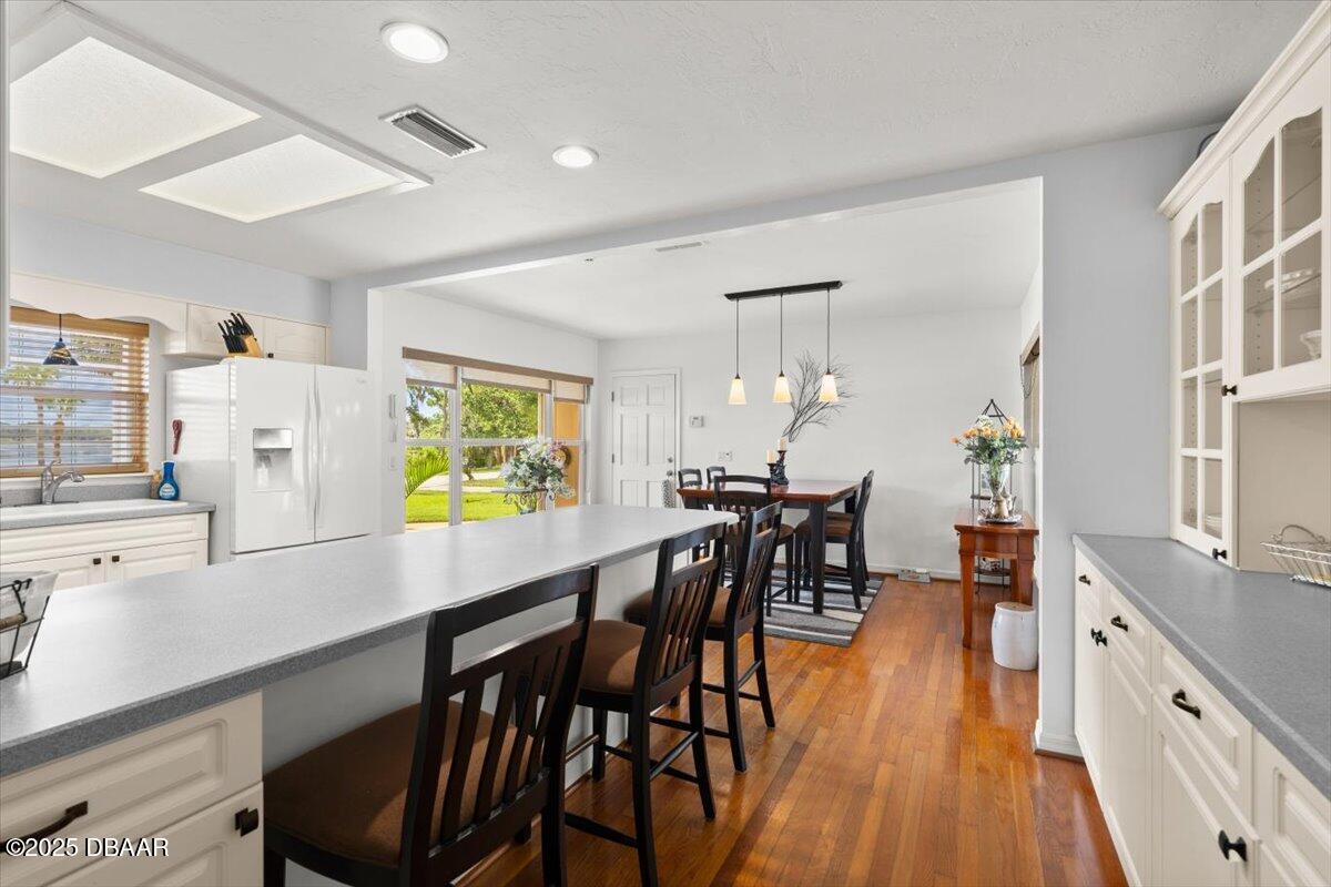 1005 North Kepler Road DeLand, FL 32724 - Photo 18 of 57 a kitchen with stainless steel appliances a dining table chairs and a refrigerator