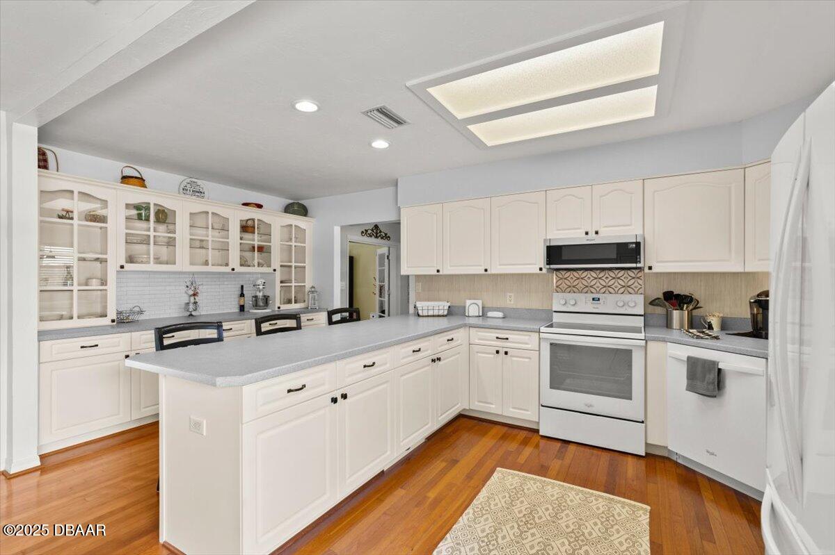 1005 North Kepler Road DeLand, FL 32724 - Photo 20 of 57 a kitchen with a stove a sink and a refrigerator
