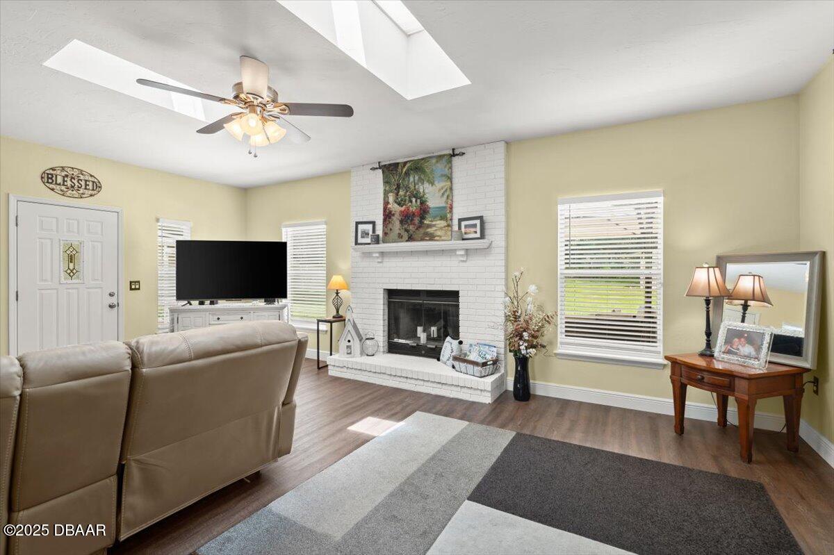 1005 North Kepler Road DeLand, FL 32724 - Photo 25 of 57 a living room with furniture a flat screen tv and a fireplace