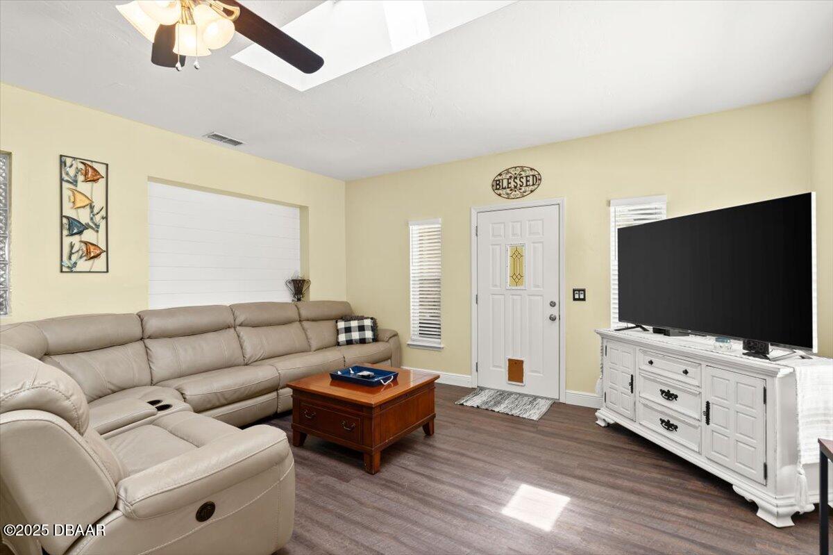 1005 North Kepler Road DeLand, FL 32724 - Photo 26 of 57 a living room with furniture and a flat screen tv